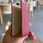 burgundy leather card holder with a cream-colored interior